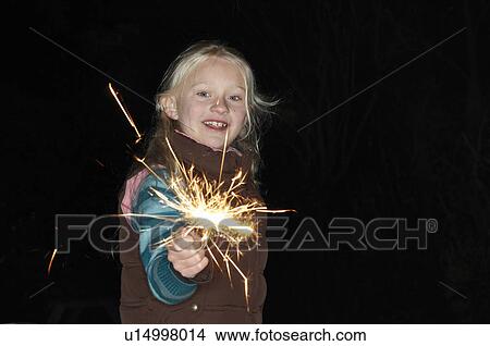 Picture - Young girl with sparkler. Fotosearch