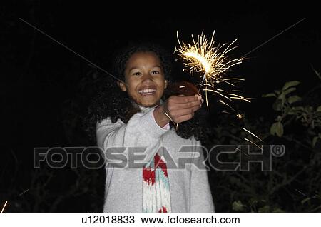 Young girl with sparkler View Large Photo Image Stock Image - Young girl with sparkler. Fotosearch