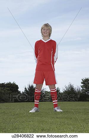 Stock Image - Young Male footballer standing. Fotosearch