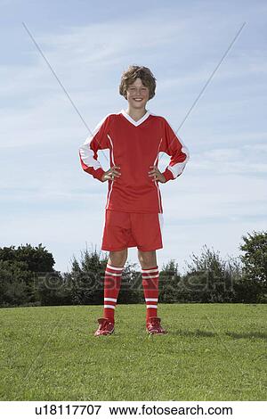 Stock Photo - Young Male footballer standing. Fotosearch