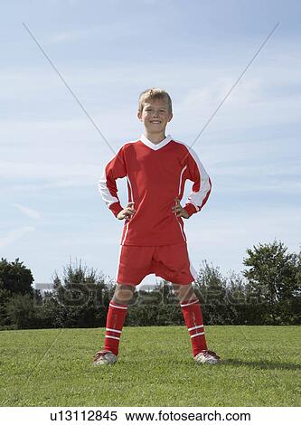 Stock Photography - Young Male footballer standing. Fotosearch