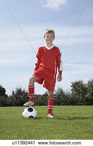 Young Male footballer with a ball View Large Photo Image Stock Image - Young Male footballer with a ball. Fotosearch