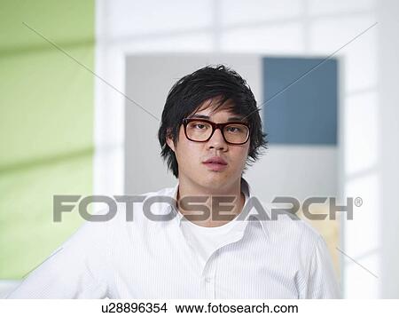Young man in loft office View Large Photo Image Picture - Young man in loft office. Fotosearch