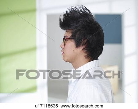 Stock Photography - Young man with mohawk and glasses. Fotosearch
