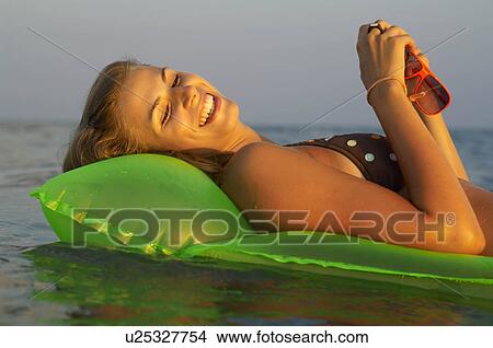 Young woman at the beach View Large Photo Image Picture - Young woman at the beach. Fotosearch