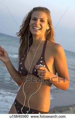 Stock Image - Young woman at the beach. Fotosearch
