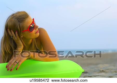 Stock Image - Young woman at the beach. Fotosearch