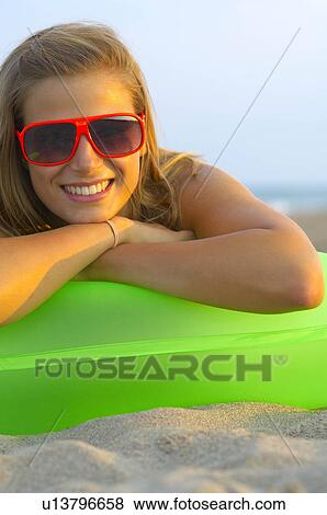 Stock Photo - Young woman at the beach. Fotosearch