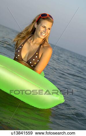 Young woman at the beach View Large Photo Image Stock Photo - Young woman at the beach. Fotosearch
