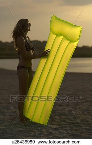 Stock Photo - Young woman at the beach. Fotosearch