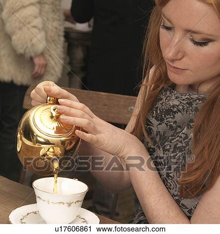 Young woman having tea in café View Large Photo Image Stock Image - Young woman having tea in café. Fotosearch