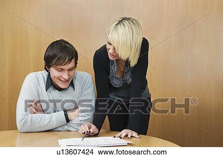 Young woman mentoring colleague View Large Photo Image Picture - Young woman mentoring colleague. Fotosearch