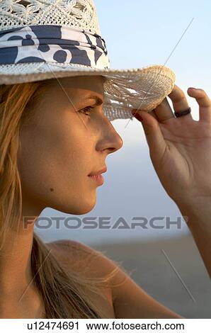 Young woman wearing a cap View Large Photo Image Stock Image - Young woman wearing a cap. Fotosearch