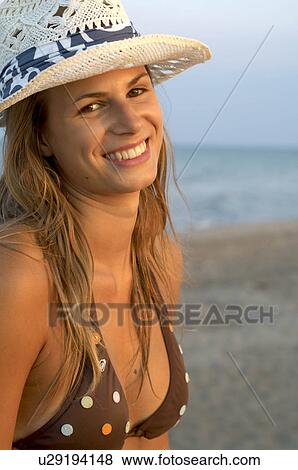 Stock Photo - Young woman wearing a cap. Fotosearch