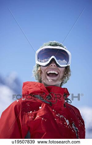 Stock Photo - Young woman wearing ski goggles. Fotosearch