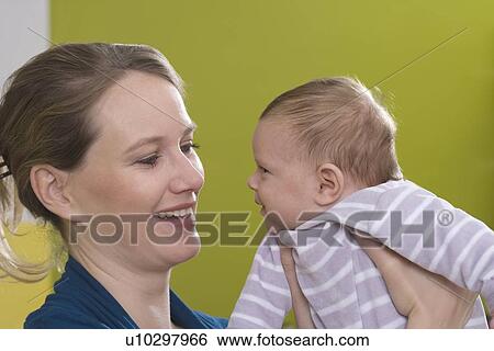 Young woman with baby View Large Photo Image Stock Photograph - Young woman with baby. Fotosearch