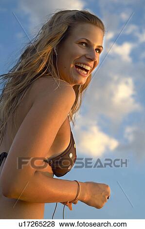 Young woman with sky View Large Photo Image Stock Photo - Young woman with sky. Fotosearch