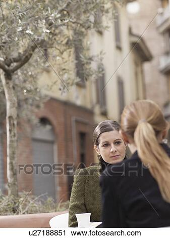Young women meeting at coffee shop View Large Photo Image Stock Image - Young women meeting at coffee shop. Fotosearch