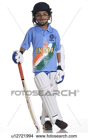 Picture - A boy in a cricketer's outfit. Fotosearch