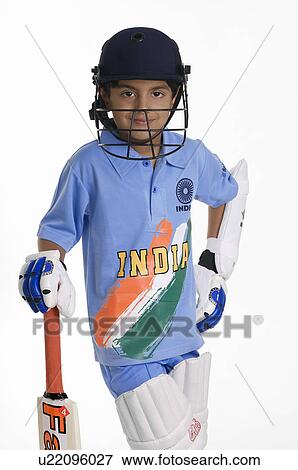 Stock Photo - A boy in a cricketer's outfit. Fotosearch