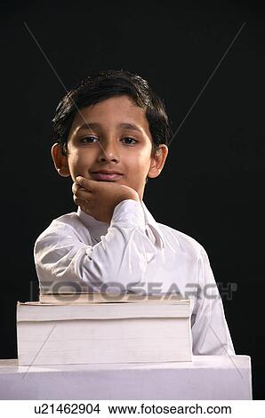 A boy leaning on stack of books View Large Photo Image Picture - A boy leaning on stack of books. Fotosearch