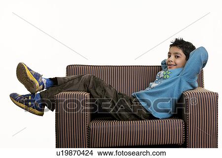 A boy lying on a sofa View Large Photo Image Picture - A boy lying on a sofa. Fotosearch