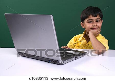 A boy with a laptop View Large Photo Image Stock Image - A boy with a laptop. Fotosearch