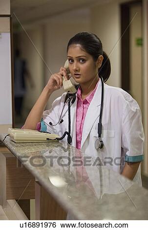 A doctor on phone View Large Photo Image Stock Photograph - A doctor on phone. Fotosearch