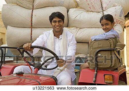 A farmer and his daughter on the tractor View Large Photo Image Stock Image - A farmer and his daughter on the tractor. Fotosearch