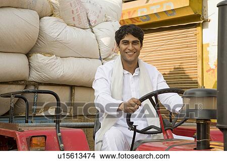 A farmer on his tractor View Large Photo Image Picture - A farmer on his tractor. Fotosearch