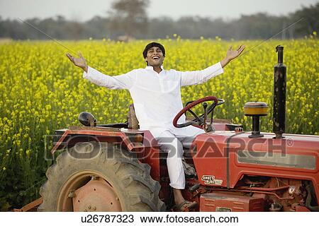 Stock Image - A farmer on his tractor. Fotosearch