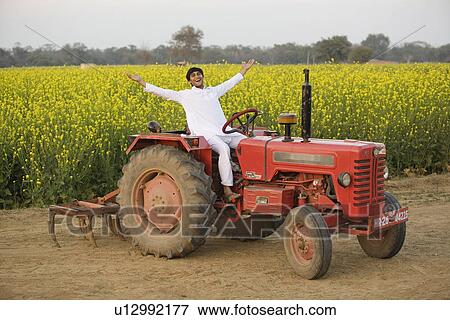 Stock Photo - A farmer on his tractor. Fotosearch