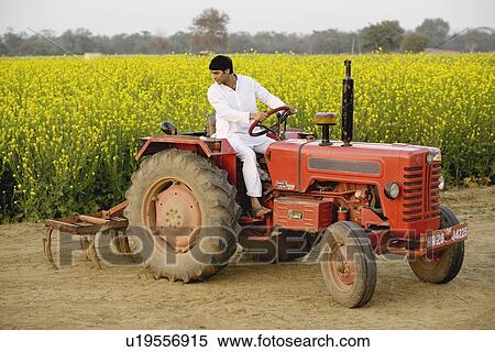 A farmer on his tractor View Large Photo Image Stock Photography - A farmer on his tractor. Fotosearch
