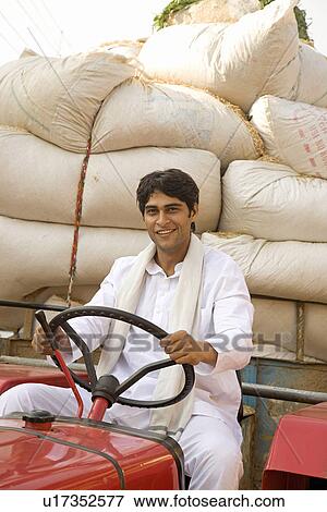 Stock Photo - A farmer with his commodities. Fotosearch