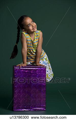 A girl holding a gift View Large Photo Image Stock Image - A girl holding a gift. Fotosearch