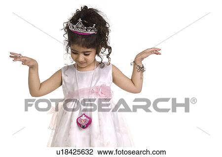 Stock Image - A girl in a party dress and tiara. Fotosearch