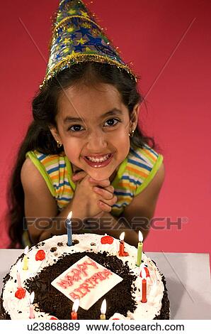 Stock Photo - A girl with her birthday cake. Fotosearch