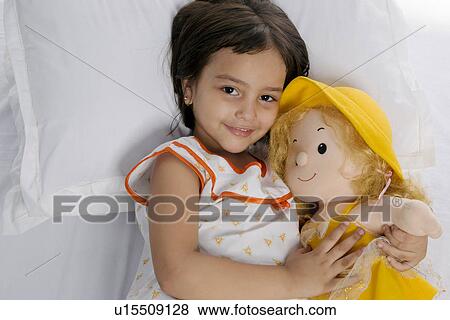 A girl with her doll View Large Photo Image Stock Photo - A girl with her doll. Fotosearch