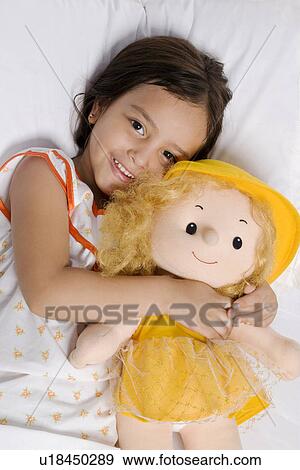 Stock Photo - A girl with her doll. Fotosearch