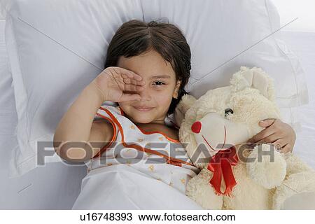 Stock Image - A girl with her teddy bear. Fotosearch