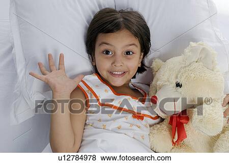 Stock Photo - A girl with her teddy bear. Fotosearch