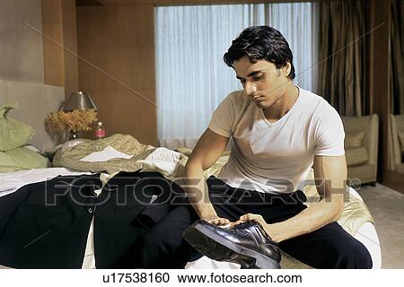 A man cleaning his shoe View Large Photo Image Stock Image - A man cleaning his shoe. Fotosearch