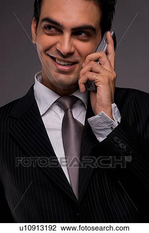 A man talking on his mobile phone View Large Photo Image Stock Image - A man talking on his mobile phone. Fotosearch