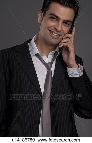 A man talking on his mobile phone View Large Photo Image Stock Image - A man talking on his mobile phone. Fotosearch