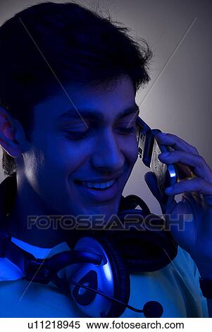 A man talking on his mobile phone View Large Photo Image Stock Photography - A man talking on his mobile phone. Fotosearch