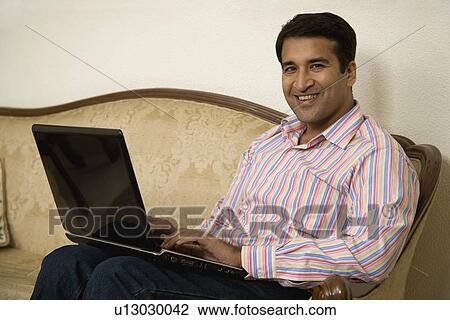 Stock Image - A man with his laptop. Fotosearch