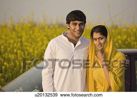 A rural couple in front of their car View Large Photo Image Stock Photo - A rural couple in front of their car. Fotosearch
