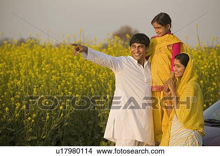 Picture - A rural family in front of their car. Fotosearch