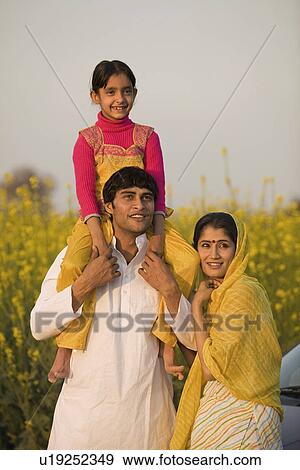 Stock Photo - A rural family in front of their car. Fotosearch