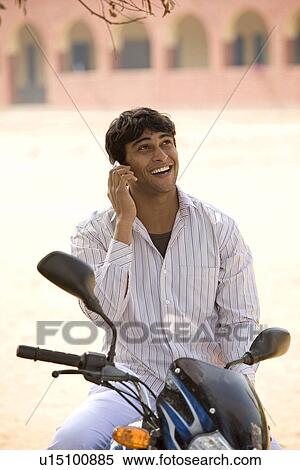 A rural man talking on his mobile View Large Photo Image Stock Photography - A rural man talking on his mobile. Fotosearch